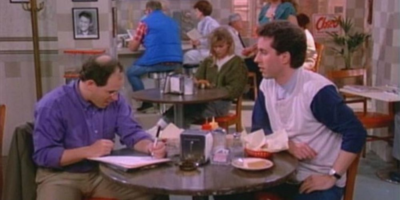   George และ Jerry นั่งที่โต๊ะอาหารใน Seinfeld