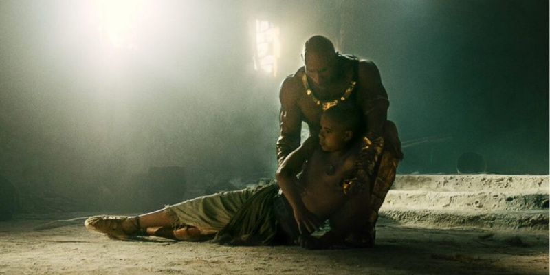   Black Adam segurando Hurut enquanto ele morre